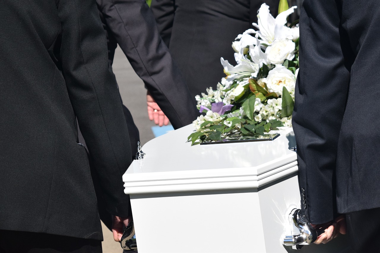 Image of pallbearers carrying a coffin