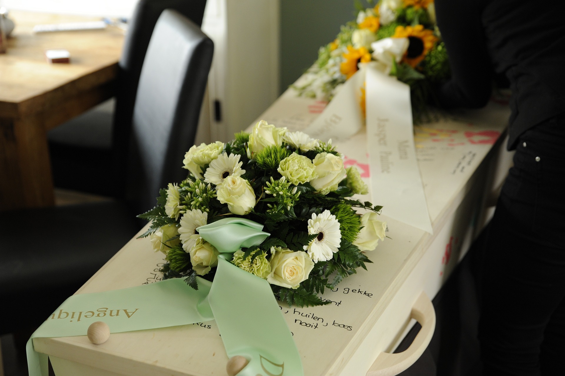 image of white coffin with flowers on top